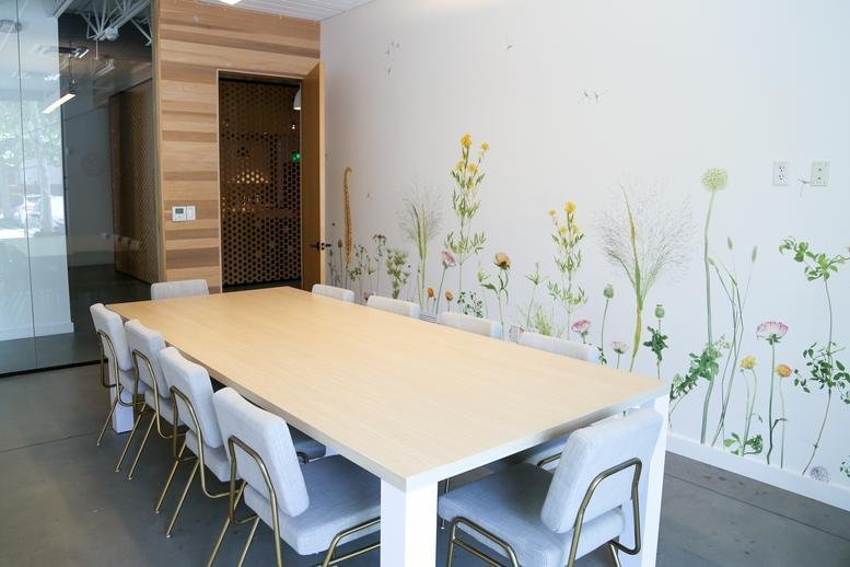Spacious meeting room at 1023, Springdale Road, Building 5A featuring a floral wall mural.