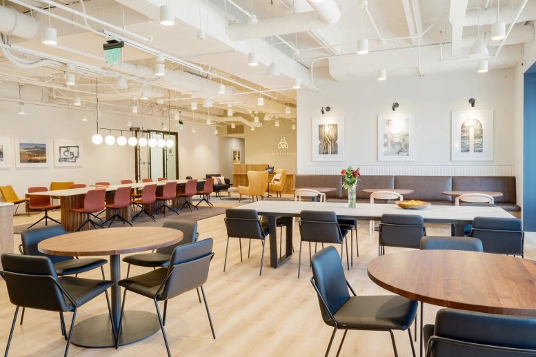 Spacious coworking lounge at 1025 Alpharetta Highway, 4th Floor, with warm lighting and diverse seating areas.