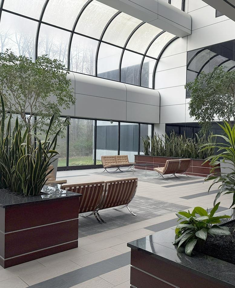 Modern lobby area with large windows and indoor plants.