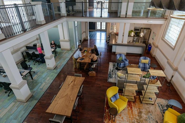 Spacious two-story coworking hub at 105, Roanoke Street East with diverse seating and high ceilings.