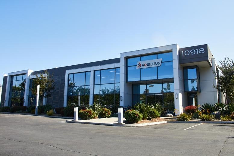 Modern exterior facade of 10918 Technology Place with glass windows and prominent address signage.