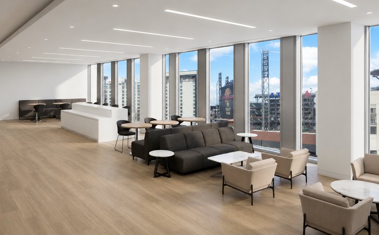 Spacious communal lounge with diverse seating options and views of a stadium at 1100, Circle 75 Parkway, Suite 400.