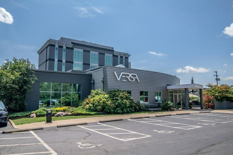 Exterior view of the contemporary gray facade at 1201 Dublin Road with manicured landscaping.