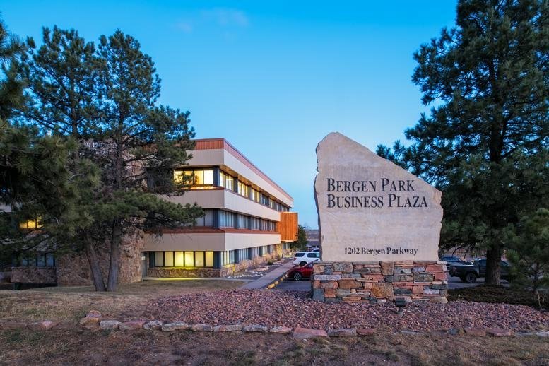 Exterior of Bergen Park Business Plaza showing the multi-story building and stone monument sign.