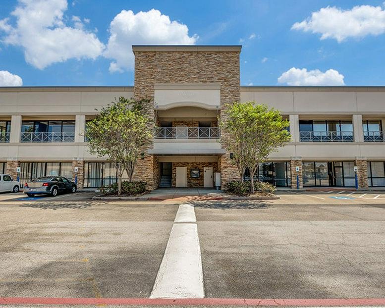 Exterior view of the stone and brick office building at 12340 Jones Rd.