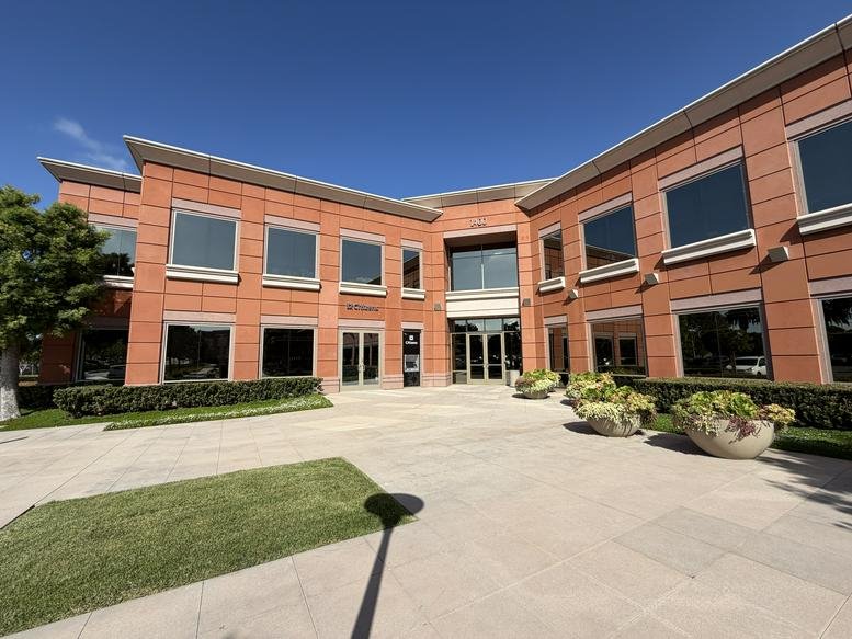 Exterior view of the brick facade and main entrance at 1400 Newport Center Drive, Suite 100 (14N).