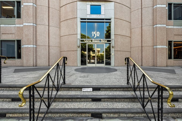 Exterior entrance of 150 S Rodeo Drive, Suites 100 & 120 featuring gold lettering and grand steps.