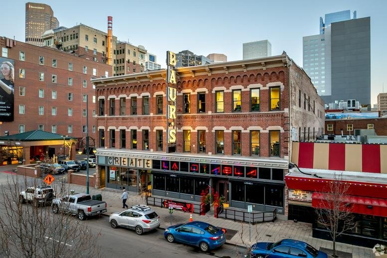 Exterior view of the historic red brick building at 1514, Curtis Street in downtown Denver.