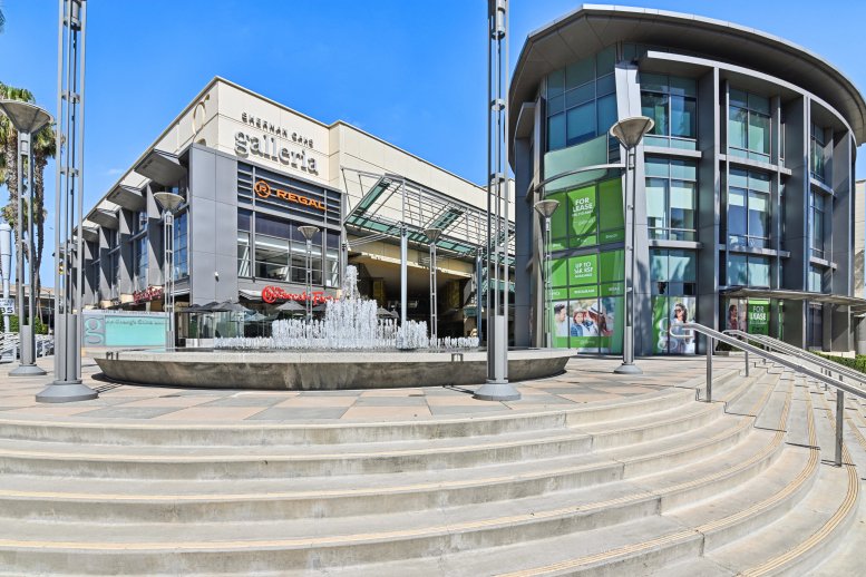 Exterior view of the modern glass-fronted 15301 Ventura Boulevard, U1 with a central fountain.