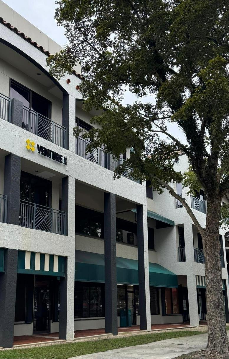 Exterior view of the white multi-story office building at 15450 New Barn Road, Suite 200.