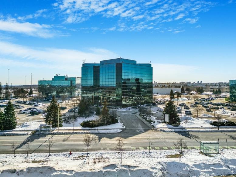 Exterior view of the glass-facade office building at 2020 Winston Park Drive.