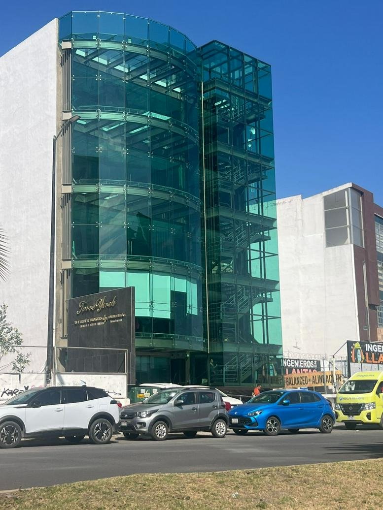 Modern glass-facade building exterior at 224 Camino Real de La Plata.
