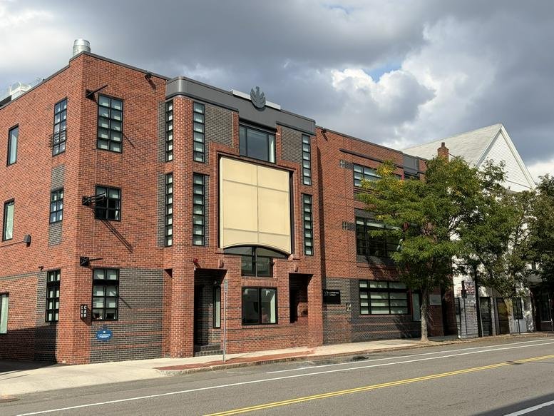 Exterior view of the brick and glass facade building at 271 Cambridge Street.