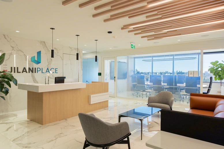 Spacious reception area at 295, The West Mall with wooden accents, marble floors, and lounge seating.