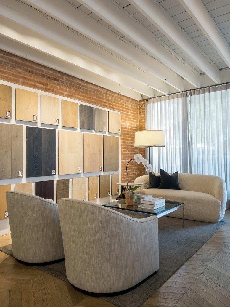Lounge area with brick walls and wood flooring samples at 3723, Greenville Avenue.