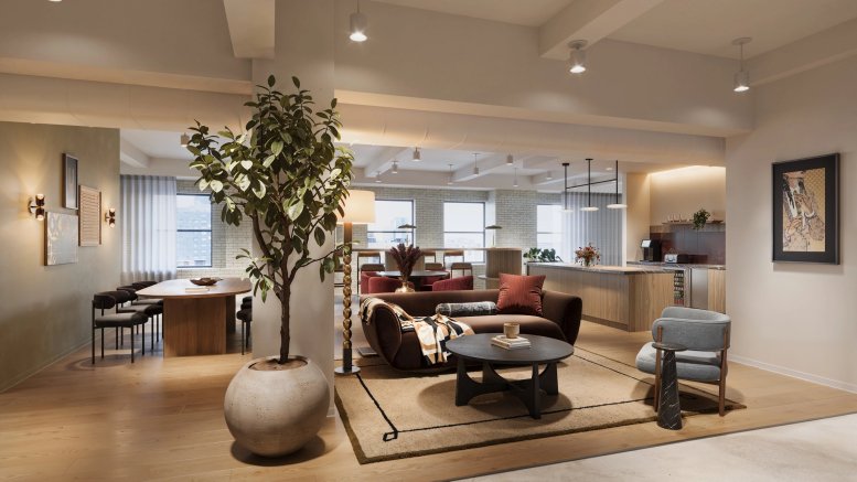 Spacious communal lounge at 386 Park Avenue South, 18th Floor featuring a velvet sofa, large plant, and kitchen area.