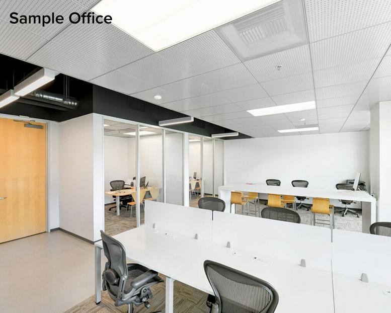 Exterior view of Redstone building with brick facade and lush green landscaping.