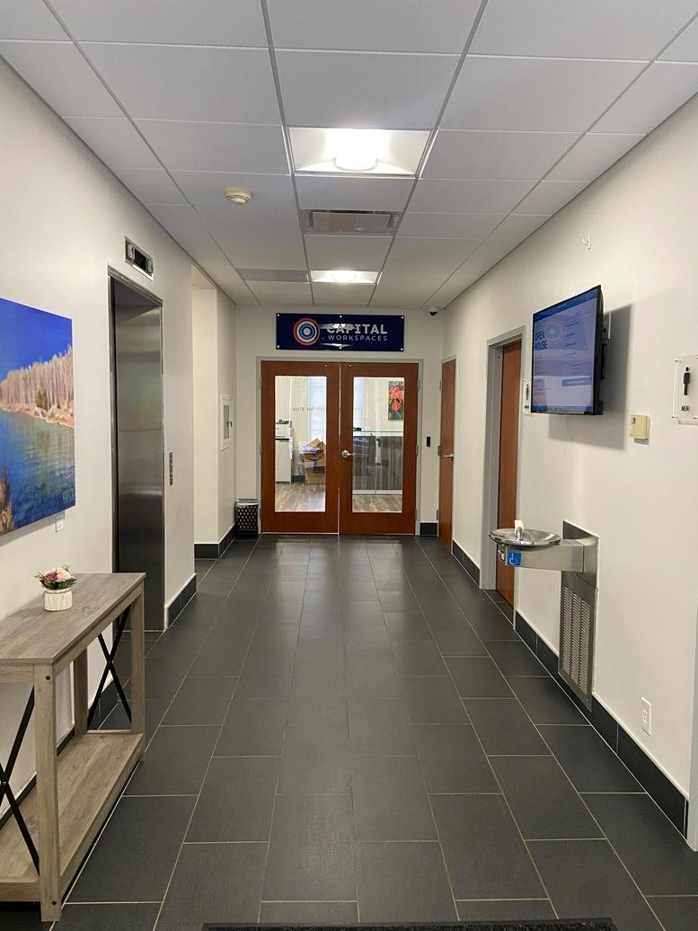 Hallway leading to the entrance of 4315, 50th Street Northwest with elevator and water station.