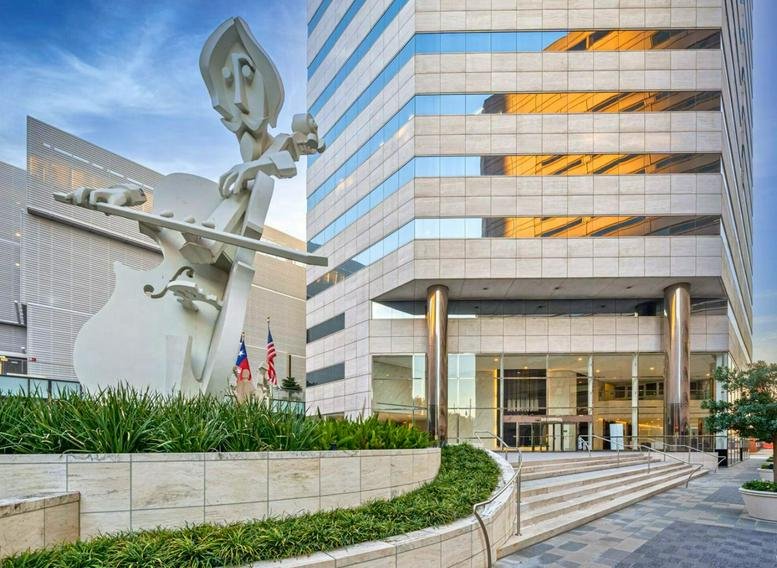 Exterior facade of the 440 Louisiana Street 900 building with a large white sculpture.