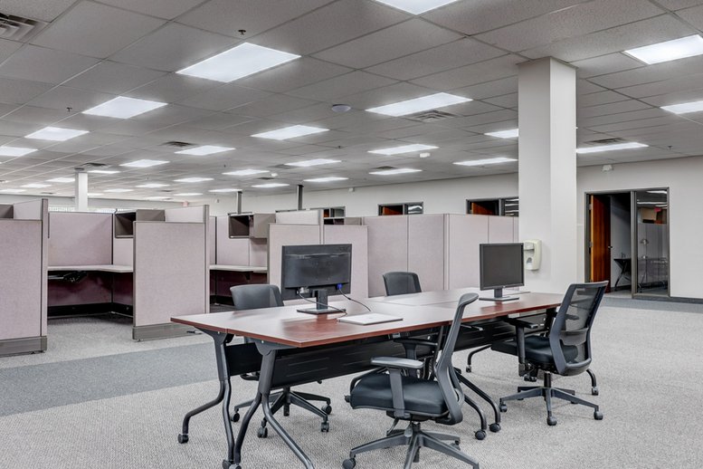 Spacious open-plan workspace at 4750 Venture Drive with large central meeting table.