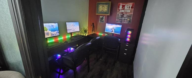 Spacious three-monitor gaming or creative setup with vibrant RGB lighting at 480 Chrysler Drive Unit 39.
