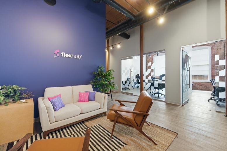 Reception lounge at 500 North Commercial Street featuring a blue feature wall and modern white sofa.
