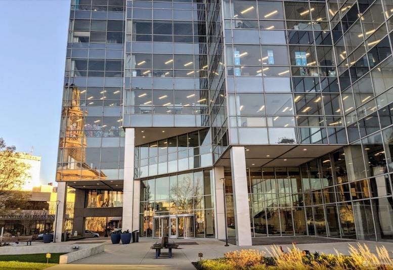 Exterior view of the glass-facade 500 West 5th Street building with reflective windows and street-level entrance.