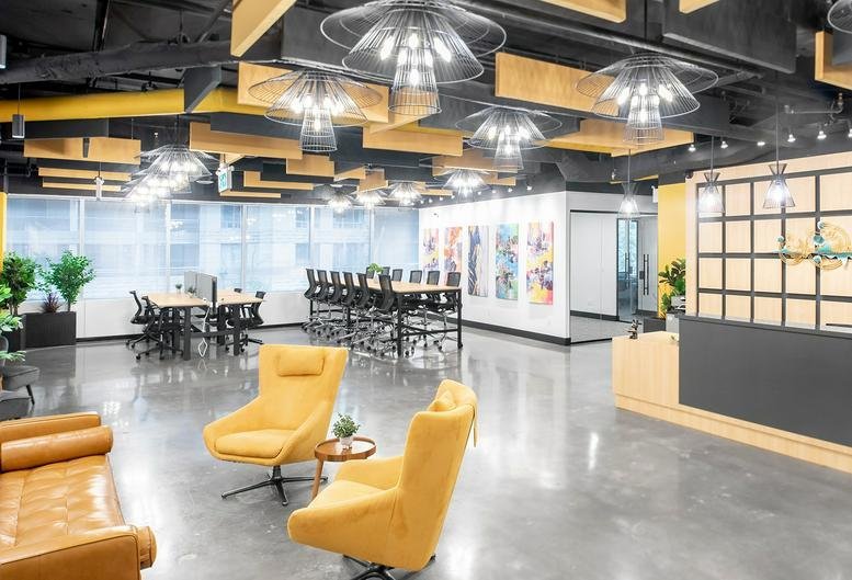 Spacious reception and lounge at 5255, Yonge Street, North York with yellow armchairs and modern lighting.