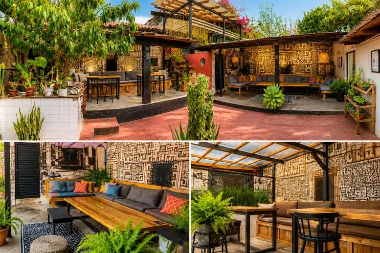 Lush courtyard at 58, Francisco I. Madero with patterned walls, outdoor lounge seating, and vibrant greenery.