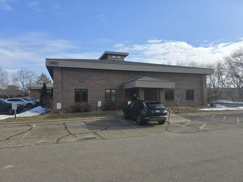 Exterior view of the brick office building at 5851 Cedar Lake Road South with a paved parking lot.