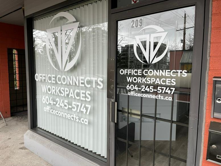 Exterior view of Office Connects Workspaces entrance with large logo on the window.