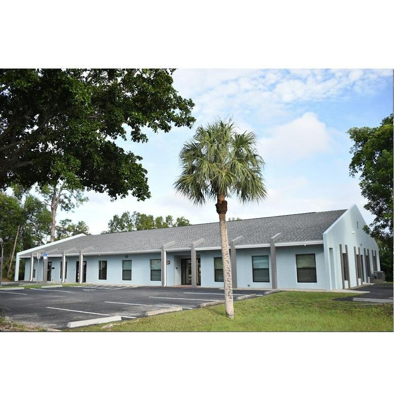 Exterior view of the light blue one-story office building at 6361 Presidential Court.