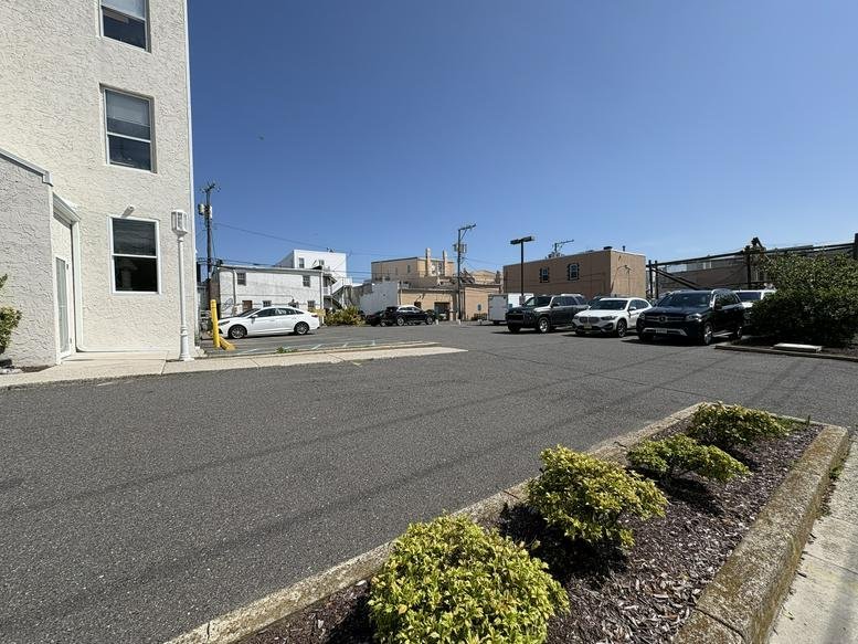 Exterior view of the Ocean City Business Center at 701 West Avenue showing the parking lot and facade.