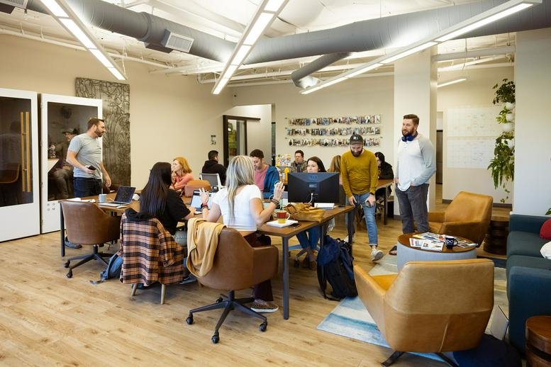 Spacious open-plan coworking area with wooden floors and collaborative seating at 705, Gold Lake Drive.