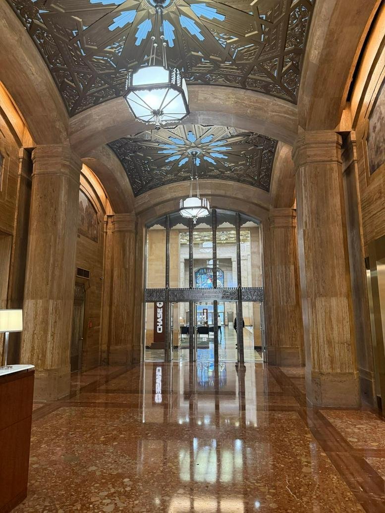 Grand lobby entrance with ornate gilded ceilings and polished stone floors.