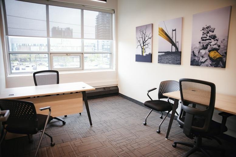 Spacious private office at 72, Victoria Street South,300 featuring a large window and guest seating.