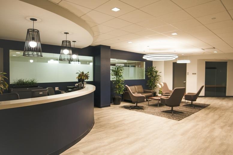 Reception and lobby at 75, South Broadway, 4th floor Suite 400 with curved desk and modern lounge seating.