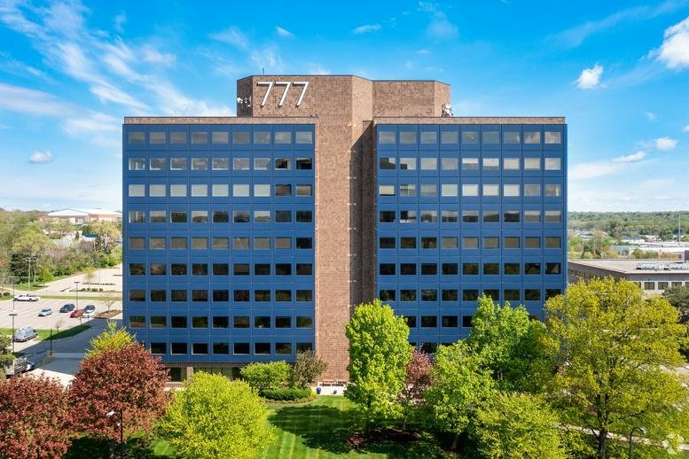 Front view of the professional dark blue multi-story office building.