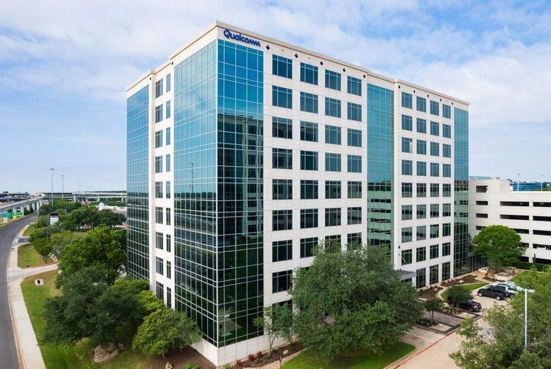 Exterior view of the multi-story glass and stone building at 9600, North Mopac Expressway, Suite 900.