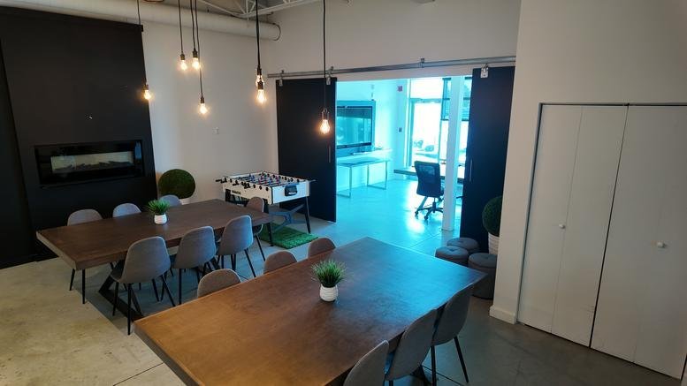 Spacious communal lounge at 9935, Rue de Châteauneuf, #120 featuring wood tables and a foosball table.