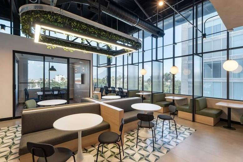 Vibrant communal area at Avenida de la juventud #100, THINK Workspace featuring booth seating and greenery.