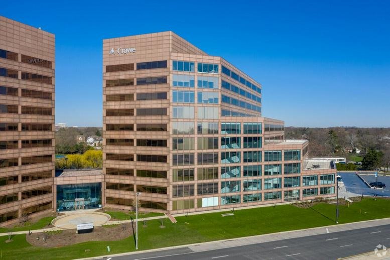 Exterior view of the geometric glass and masonry facade of 1 Mid America Plaza.