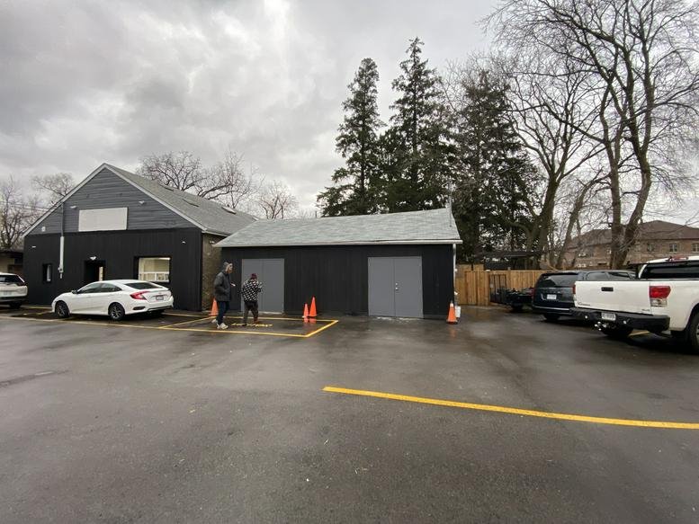 Exterior of the modern dark grey building at 10225 Yonge Street, Unit R.