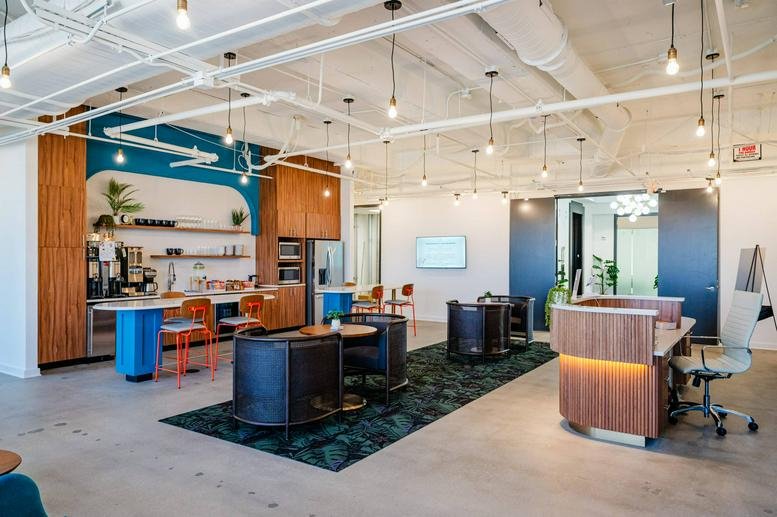 Spacious communal lounge and reception area at 104 S Main Street with modern furniture and high ceilings.