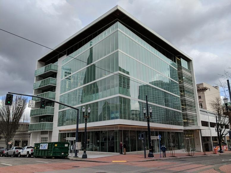 Exterior view of the glass-fronted office building at 1155 SW Morrison Street.