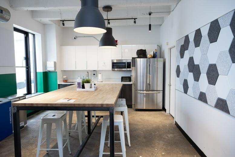Modern kitchen at 1212 North Ashland Avenue with a wood-top island and stainless steel appliances.