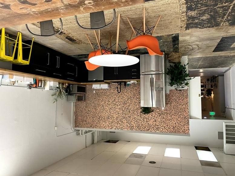 Modern kitchen and dining area at 122 East Main Street, Downtown, Medford, Oregon with orange chairs.