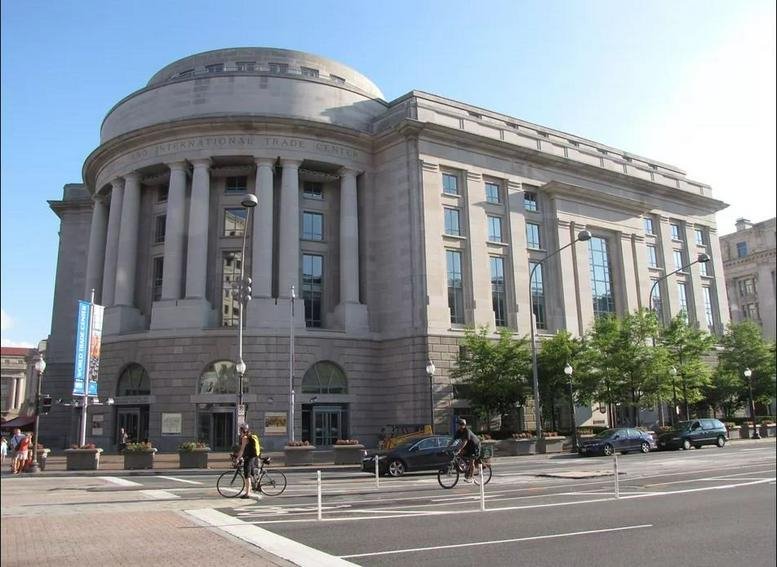 Grand neoclassical exterior facade of 1300 Pennsylvania Avenue, Washington DC with arched windows.