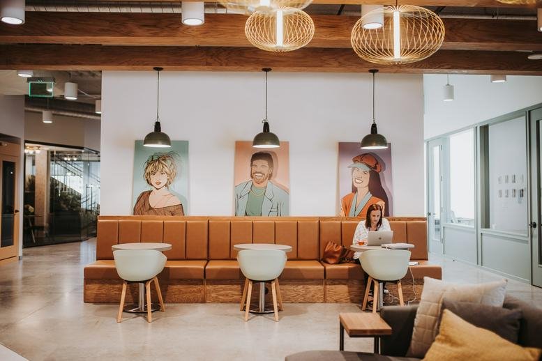 Spacious common area with leather booths, modern seating, and pendant lighting.