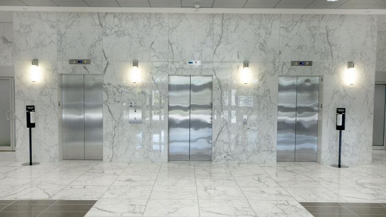 Spacious lobby with marble walls and floor at 1525 Carling Avenue.